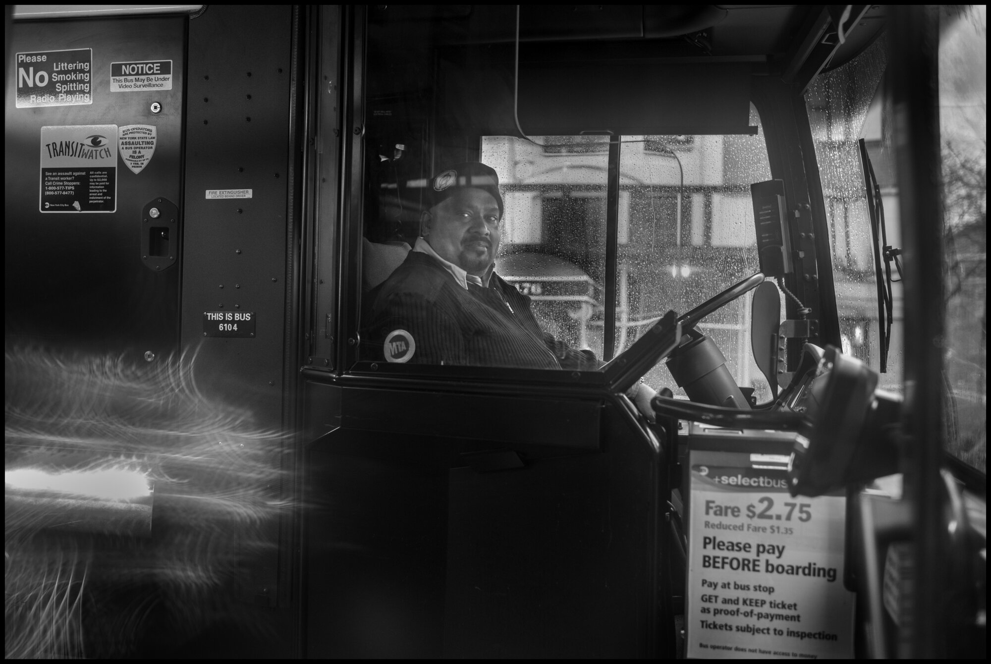  A public transport bus driver at the corner of 86thStreet and Amsterdam opens the door kindly to me for a photograph before driving off with a smile.  March 23, 2020. © Peter Turnley.  ID# 02-010 