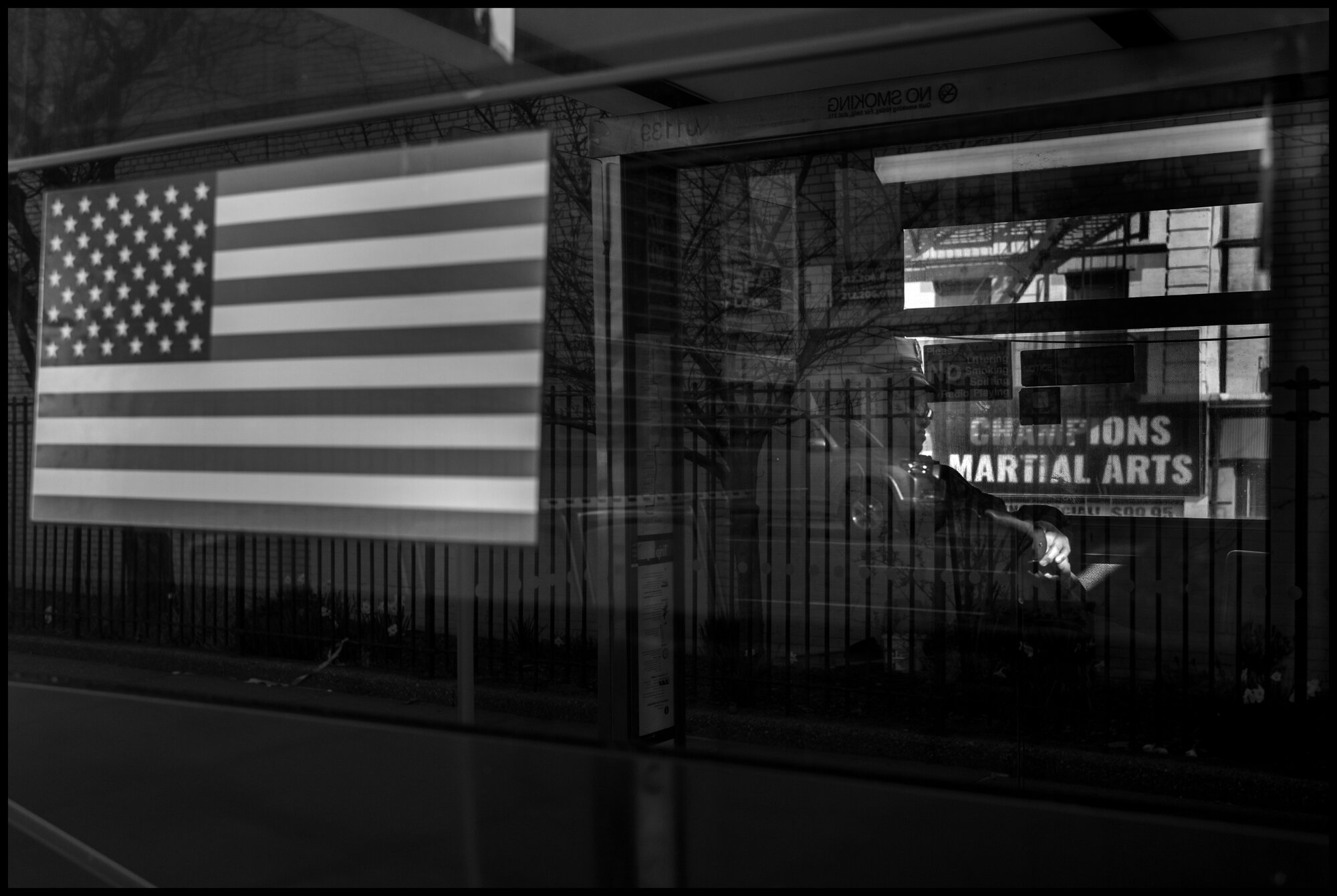  A public worker rides home on a bus stopped on Columbus Ave.  March 23, 2020. © Peter Turnley.  ID# 02-014 