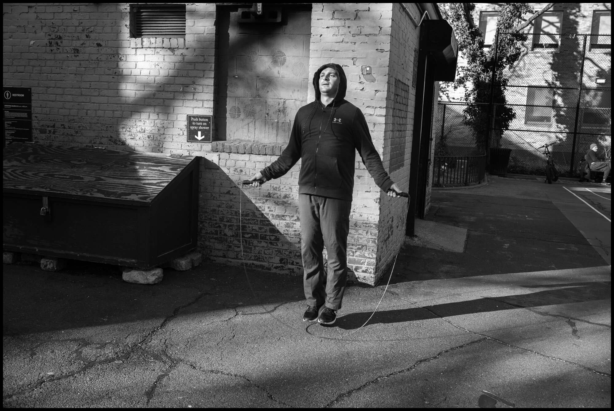  Jacob, a nurse who works at Sloan Kettering, skips rope to get air and relaxation, safely away from others at the Happy Warrior Playground on Amsterdam Ave.  March 24, 2020. © Peter Turnley.  ID# 03-006 