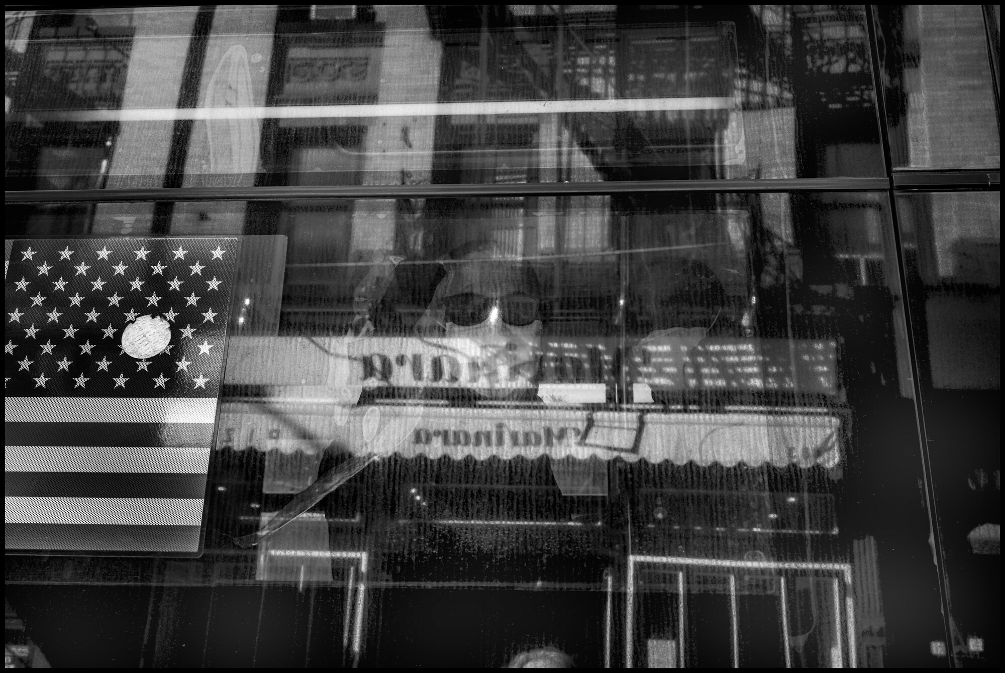  A man stairs out of a bus heading north on Amsterdam Ave.  March 24, 2020. © Peter Turnley.  ID# 03-014 