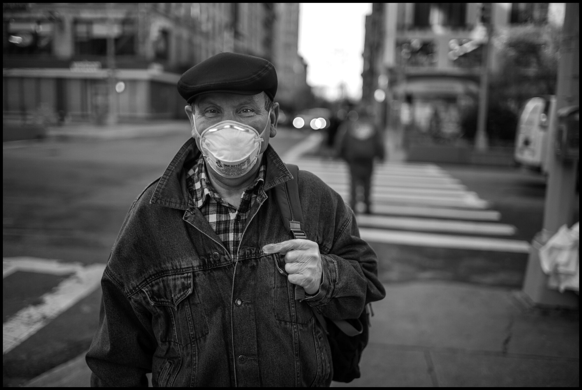  A portrait of a man walking across the street at 80thand Broadway. I asked him if I could photograph him and he said yes, but I don’t speak English.  March 24, 2020. © Peter Turnley.  ID# 03-015 