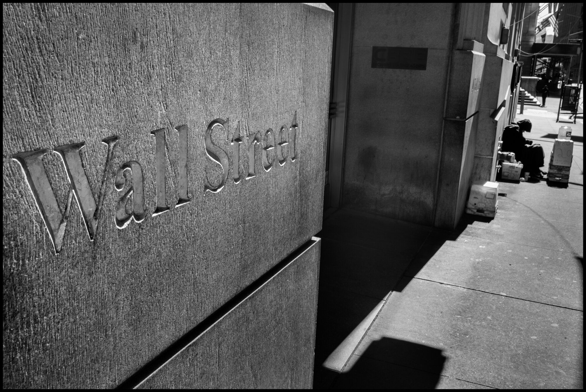  A woman begs for money for food on Wall Street, the financial center of the world.  March 26, 2020 ©Peter Turnley  ID# 04-003 