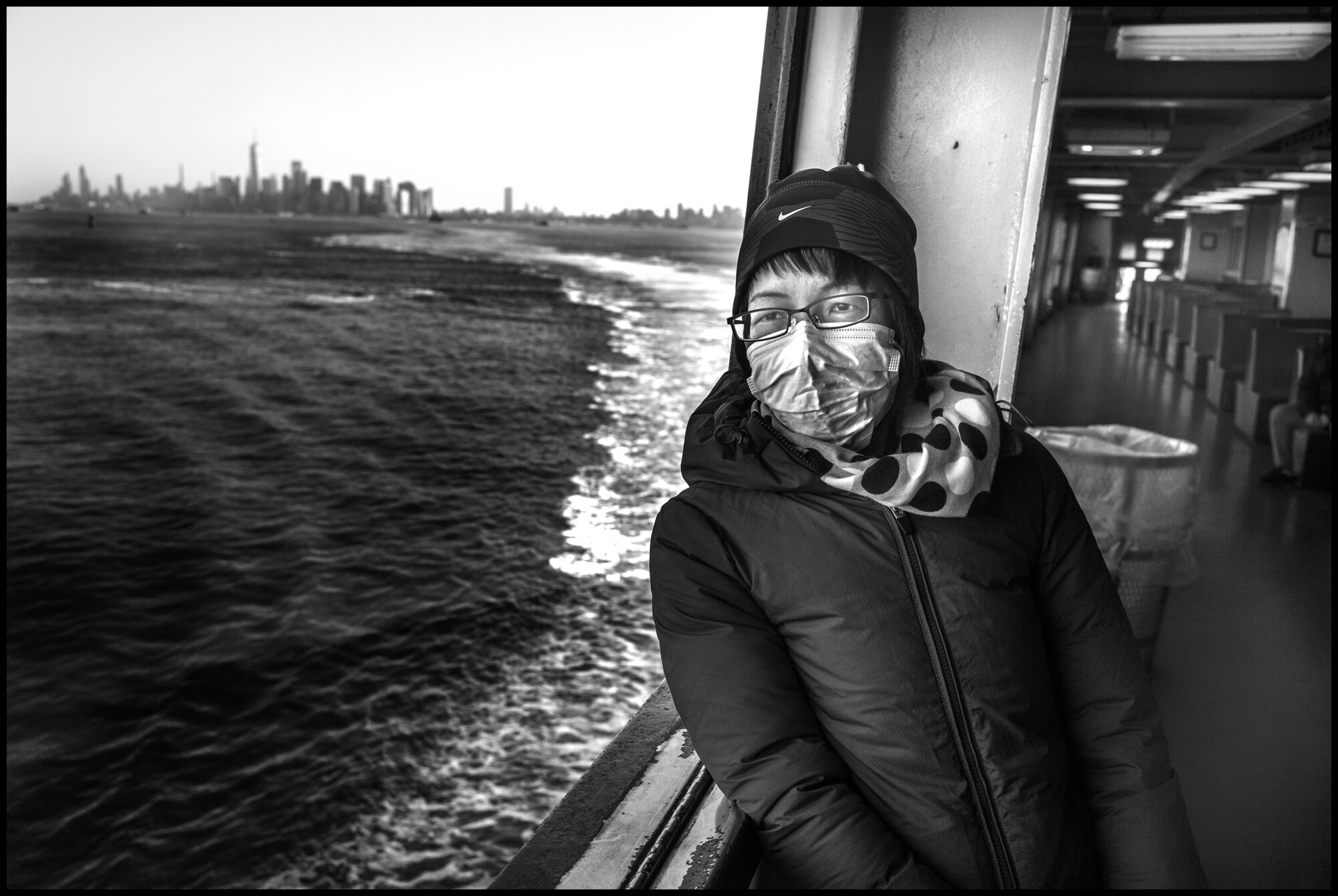 Lian, 44, is originally from China and told me she speaks very little English and works as a home attendant on Staten Island and takes the ferry daily there for her work.  March 26, 2020 ©Peter Turnley  ID# 04-009 