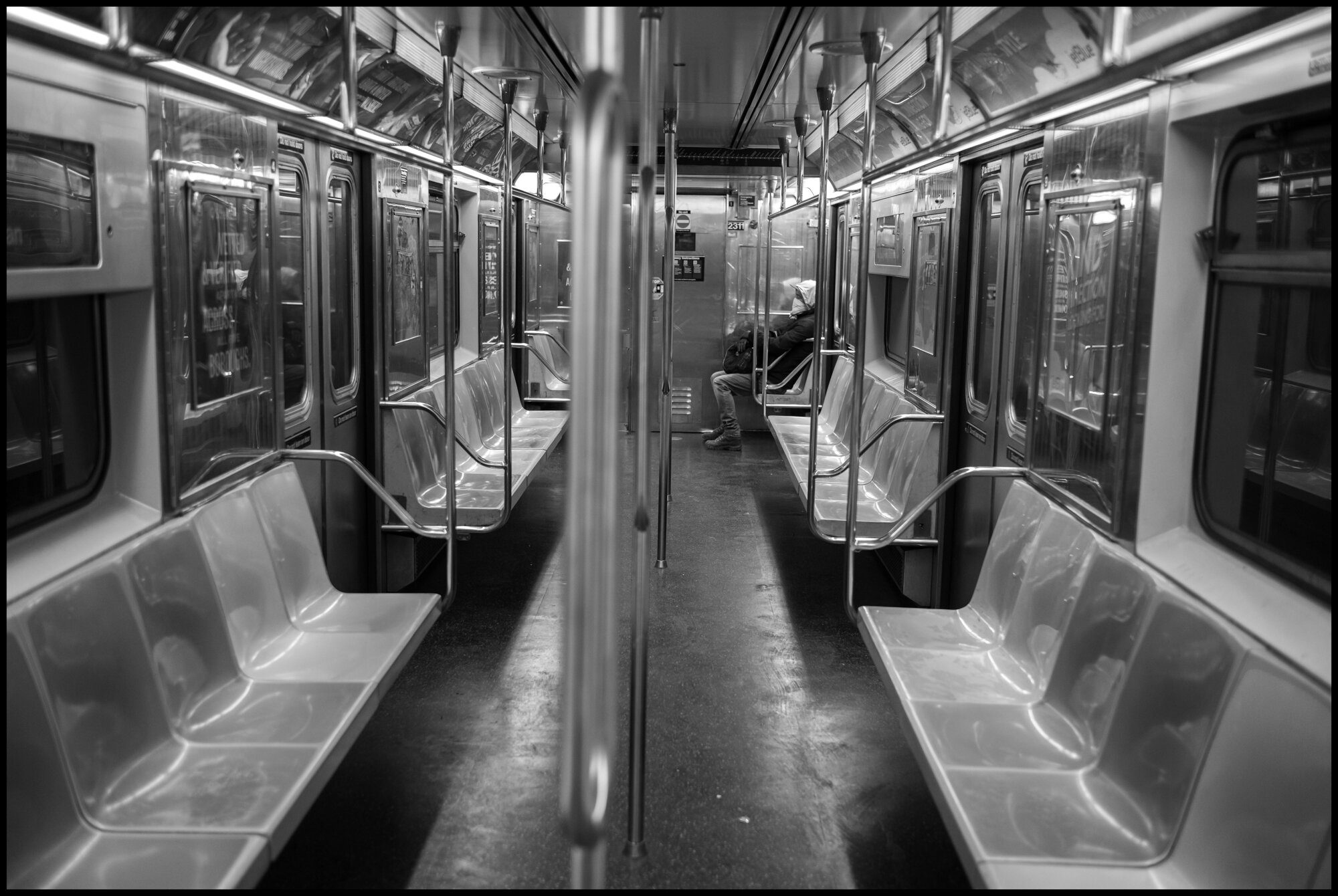  A lone passenger rides south on the #1 train.  March 26, 2020 ©Peter Turnley  ID# 04-017 