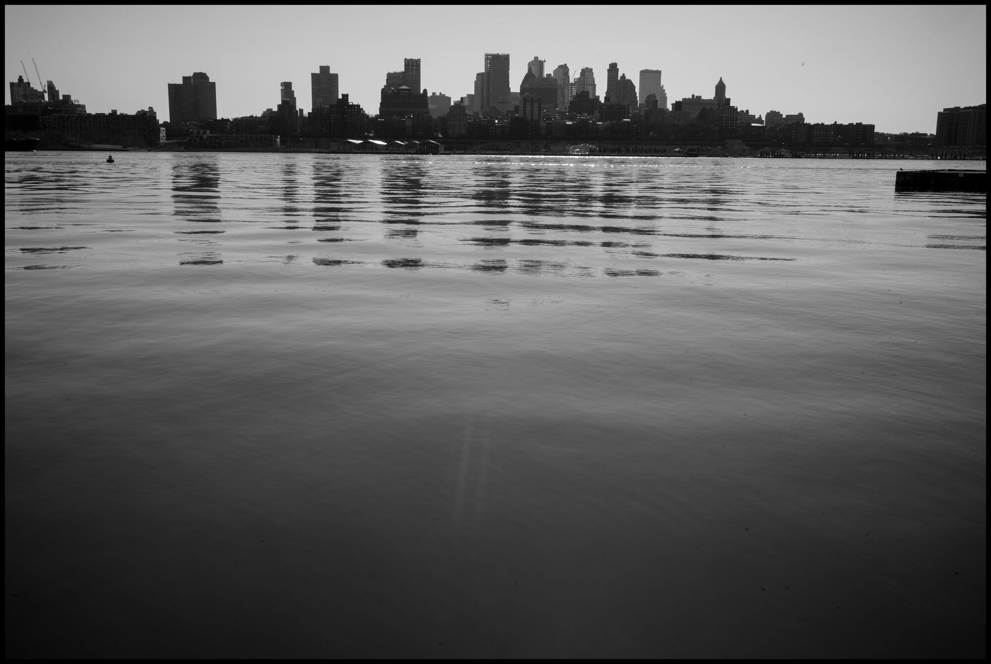  The waters of the Bay of Manhattan. We are definitely all living through a time of very troubled waters, and yet there are days, when smooth calm light can help the heart for the journey ahead.  March 26, 2020 ©Peter Turnley  ID# 04-019 