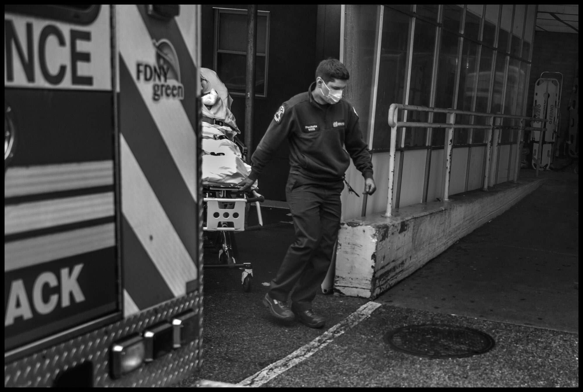  An EMT takes a stretcher with a new patient into the emergency room of Elmhurst Hospital in Queens-one of the most intense scenes of urgent care for coronavirus victims in New York and the US.   March 29, 2020. ©Peter Turnley.   ID# 09-004 