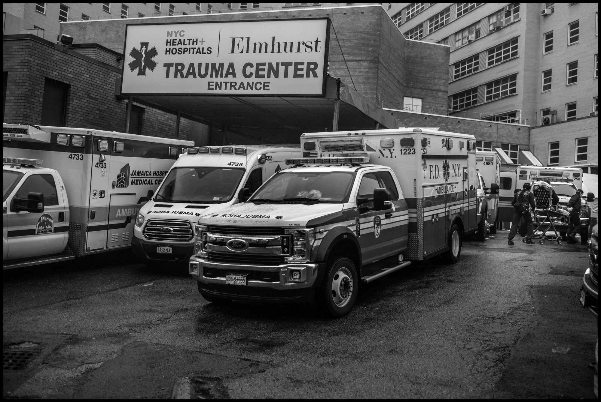  At the back of Elmhurst Hospital in Queens-the ground zero of the coronavirus crisis in New York and the United States, ambulances line up to deliver urgent care patients to the emergency room.   March 29, 2020. ©Peter Turnley.   ID# 09-013 