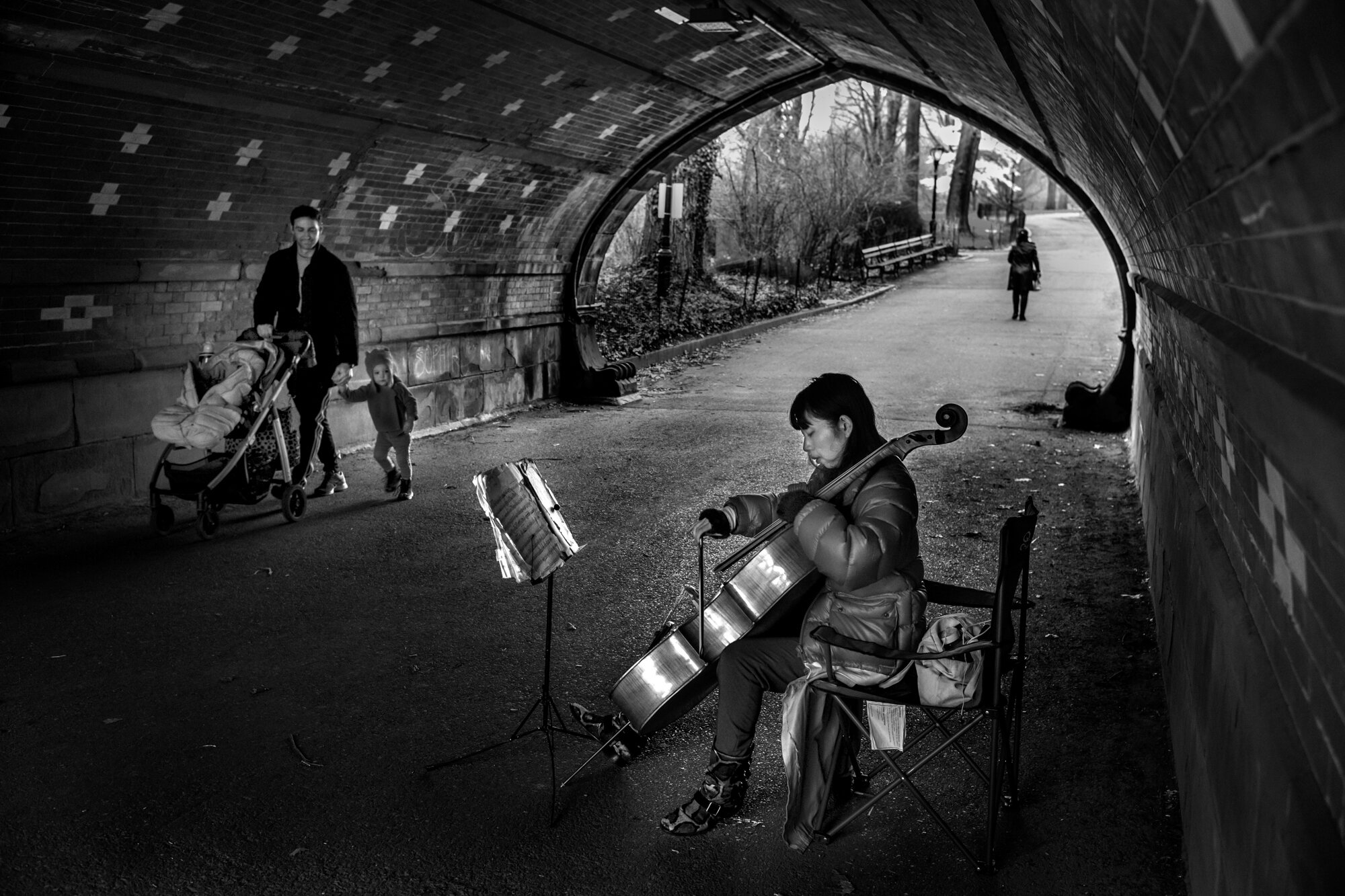  Chi, in her 20ties, originally from Tokyo, playing the Cello in Central Park.  March 31, 2020. ©Peter Turnley.  ID# 09-014 