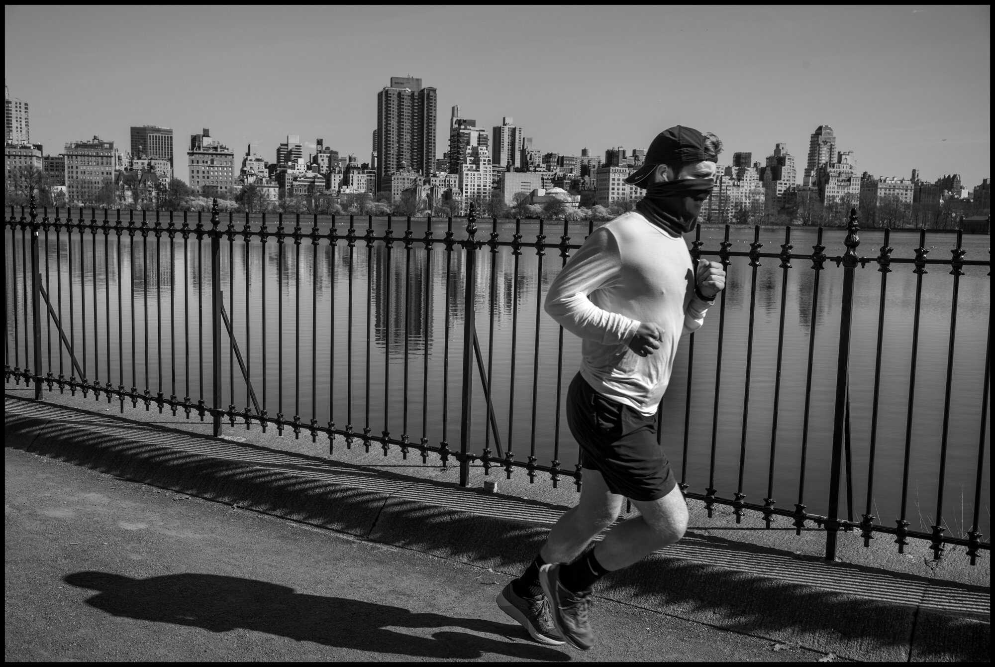  A young man runs by the Resevoir in Central Park wearing a cloth mask, which has now been ordered by the Governor of New York for all person when they are outside. Monday was one of the most beautiful early spring days yet in New York, and after now