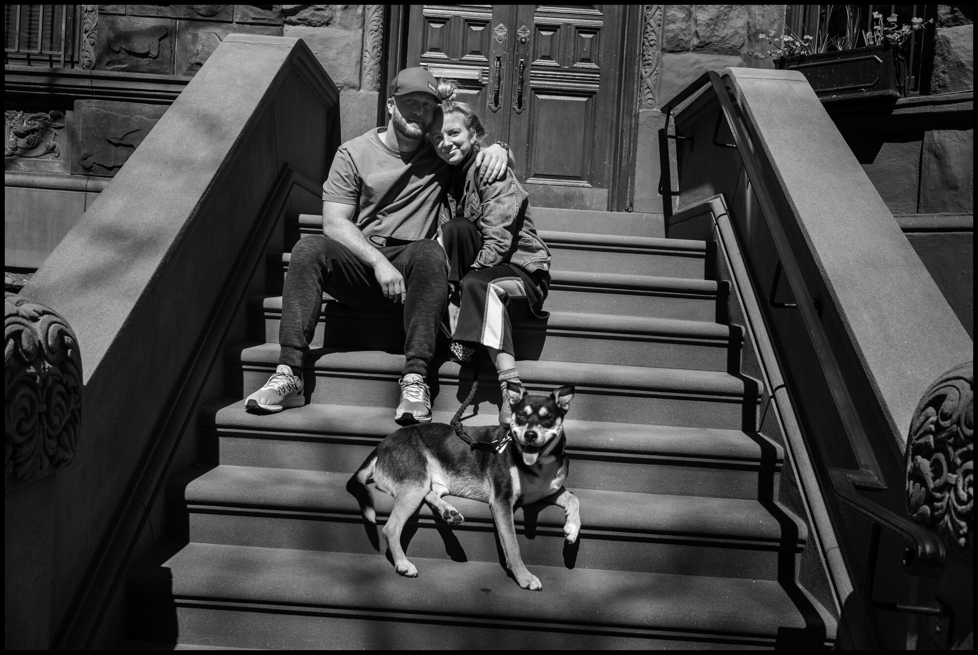  Two neighbors, Collin and Mattie, sit outside on the their steps with their dog, Winslow.Winslow is a rescue dog and Mattie explained, “she is used to being by herself-she’s like some times, please leave”. Mattie is an actress and Collin is a barten