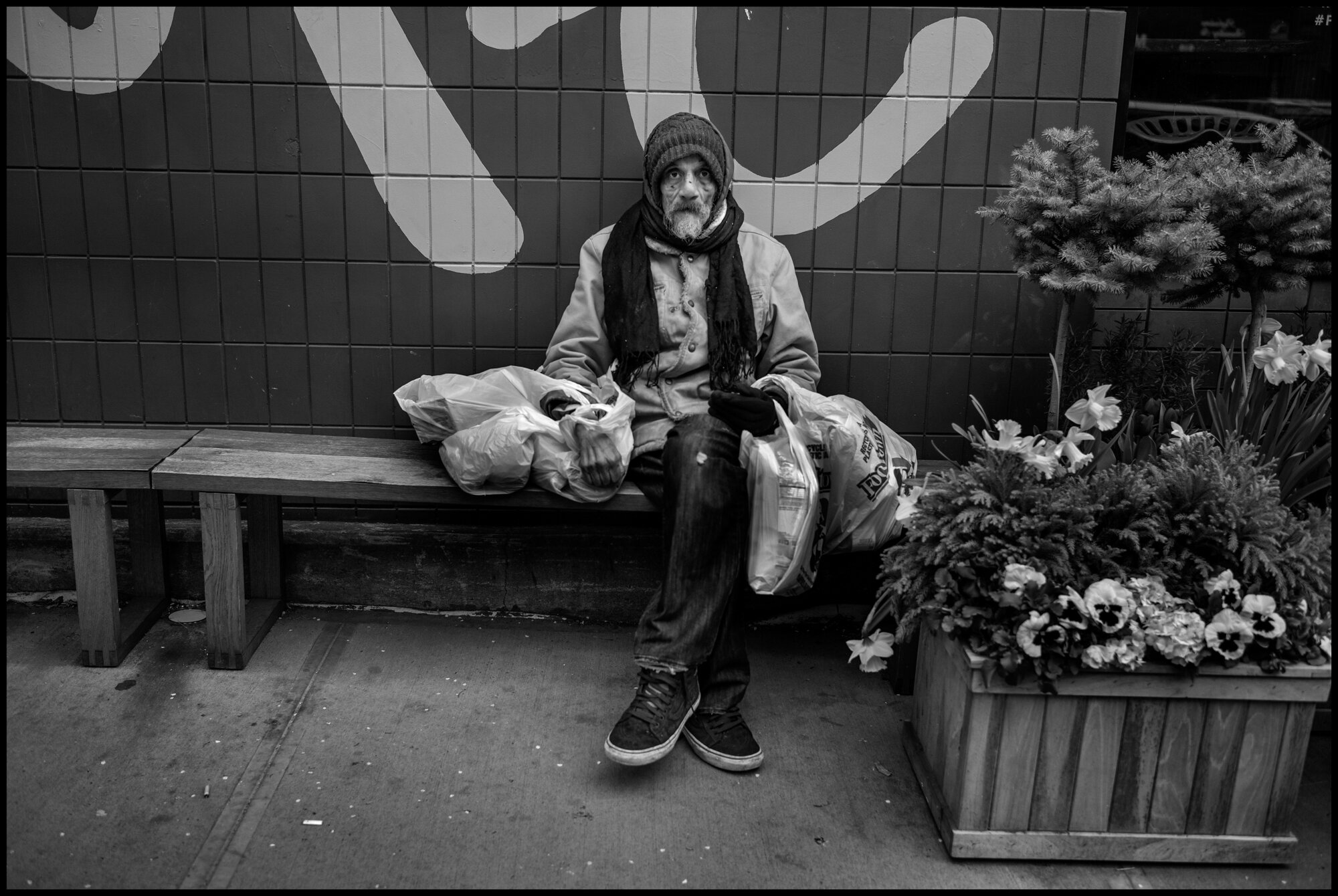  Frank, 77, sits on a bench on Columbus Ave. near 85 street. I asked how he was doing, and he answered, “so, so”.  April 5, 2020. © Peter Turnley  ID#&nbsp;14-005 