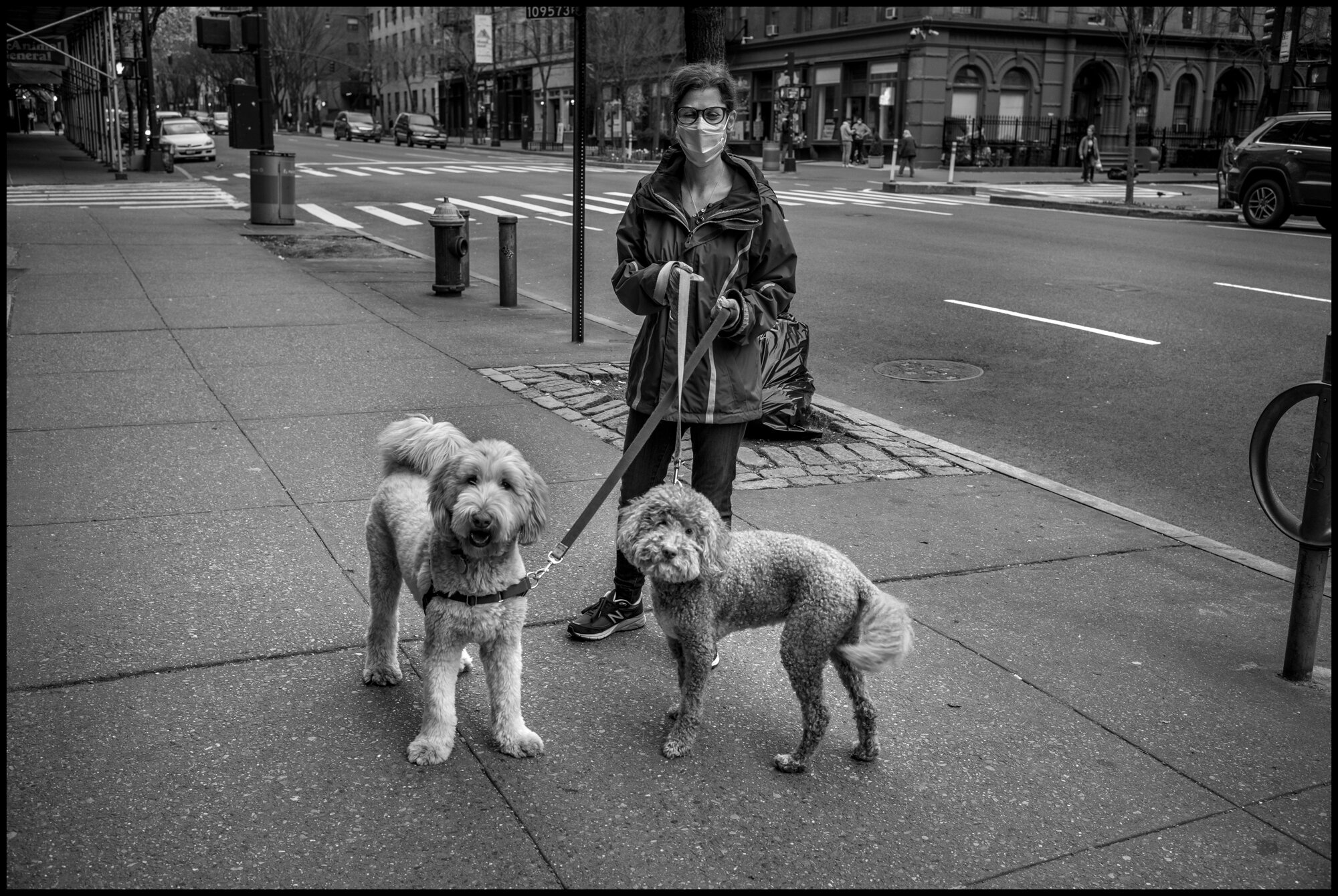  Jill walks on the Upper Westside of New York on Columbus Ave. with her two dogs, Tashi, and Yuki, both Labradoodles. She told me, “they are stressed because they pick up on my stress.”  April 5, 2020. © Peter Turnley  ID#&nbsp;14-012 