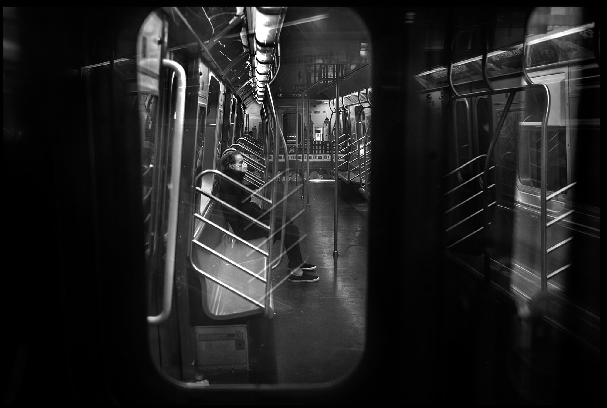  A man rides the train alone from Queens towards Manhattan.   March 29, 2020. © Peter Turnley   ID# 15-001 