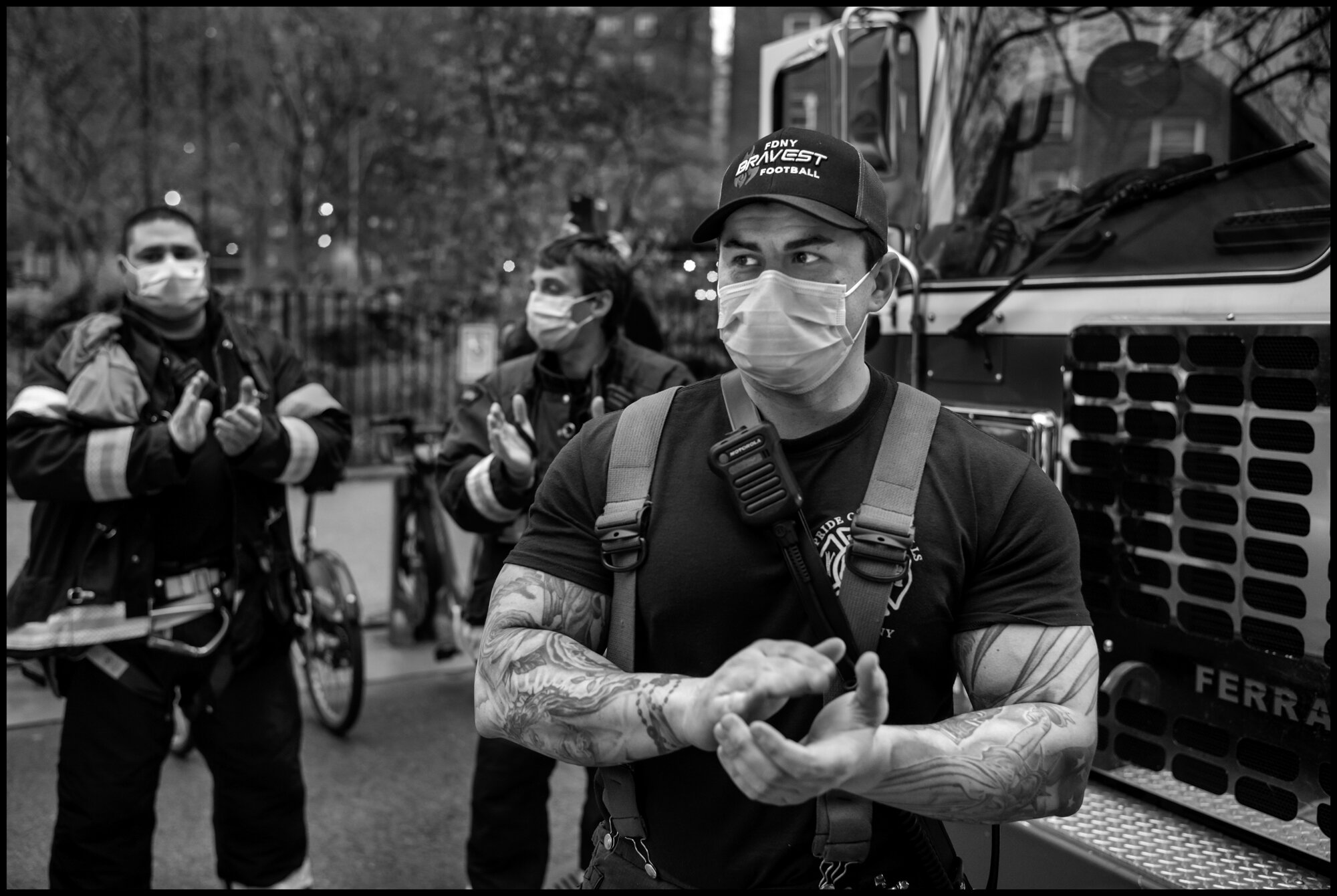  Firemen from with FDNY 43 Truck “El Barrio’s Bravest” stand outside Mount Sinai Hospital and cheer and applaud the work all hospital and essential workers.   April 19, 2020. © Peter Turnley  ID# 26-002 