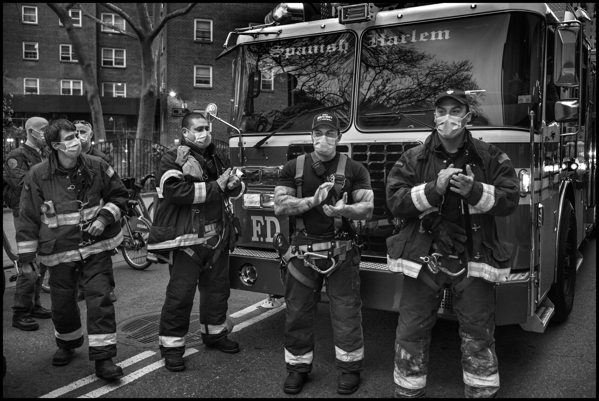  Firemen from with FDNY 43 Truck “El Barrio’s Bravest” stand outside Mount Sinai Hospital and cheer and applaud the work all hospital and essential workers.   April 19, 2020. © Peter Turnley  ID# 26-008 