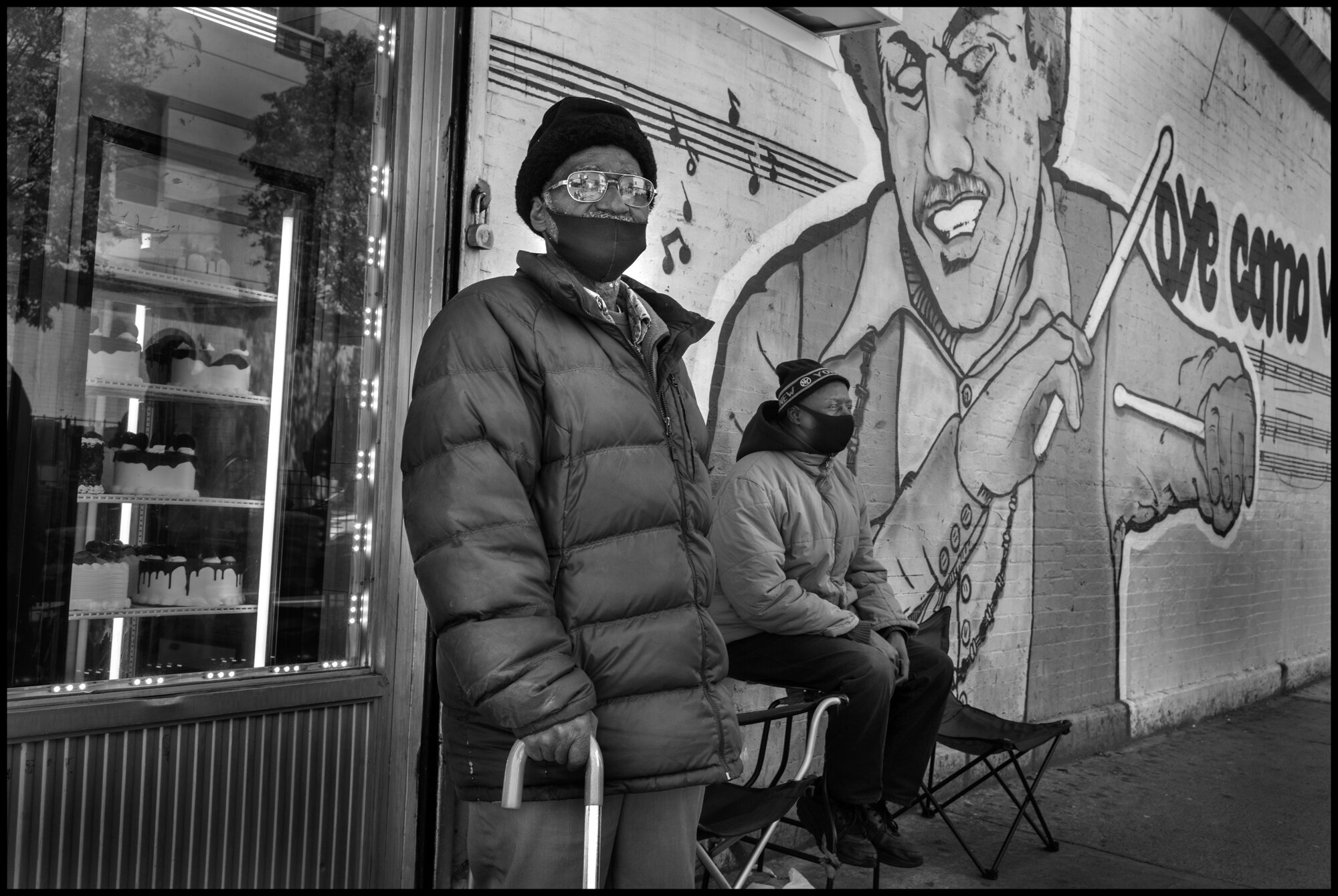  Demetrio, 82, moved from Puerto Rico to Spanish Harlem 64 years ago. Seni,54, is from Senegal . Demetrio has lived most of his life in “El Barrio”. He told me in Spanish, “it’s not El Barrio anymore”.   April 19, 2020. © Peter Turnley  ID# 26-021 