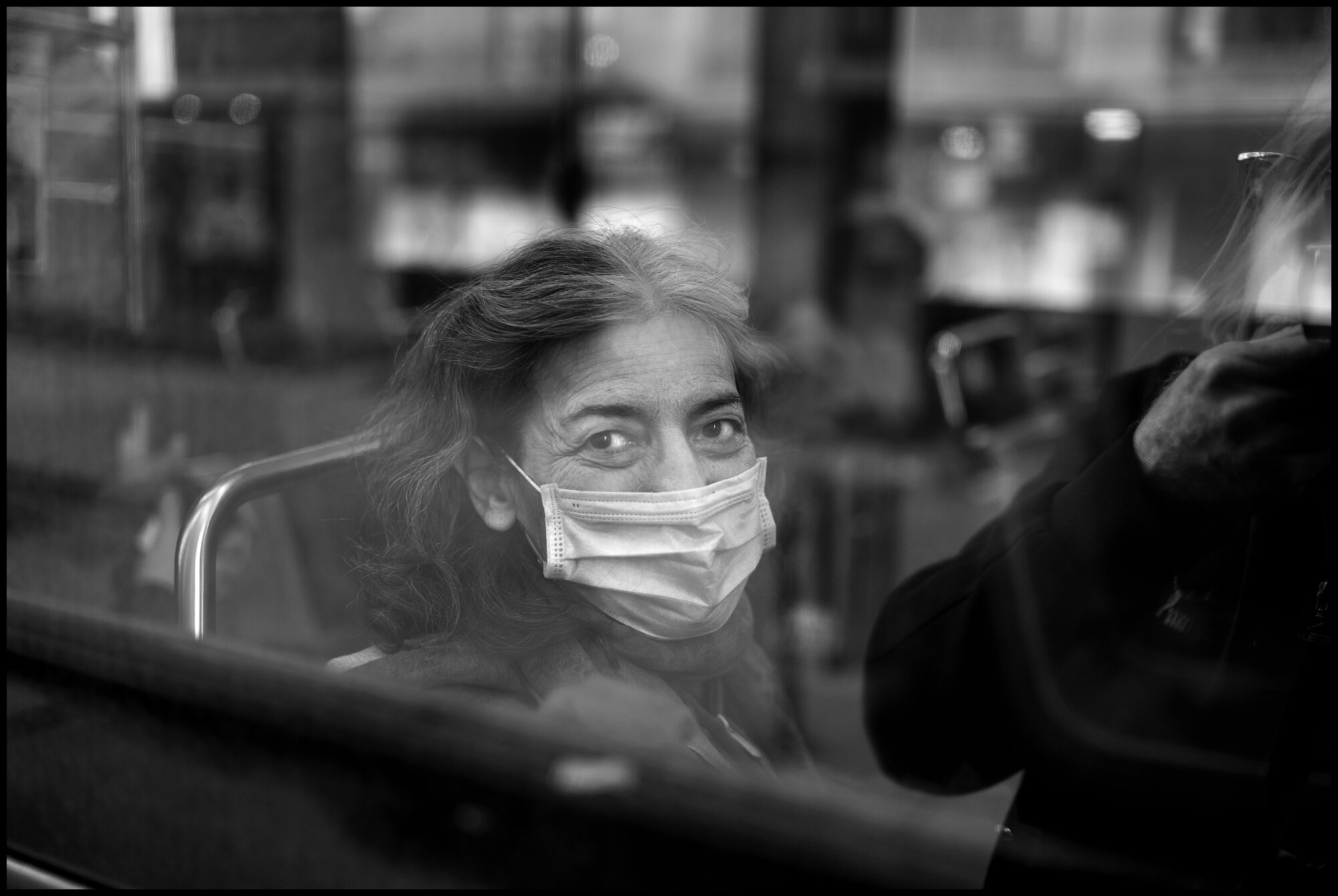  A woman rides a bus up Amsterdam Avenue near 81 st. Street.   March 24, 2020. © Peter Turnley.   ID# 03-004 