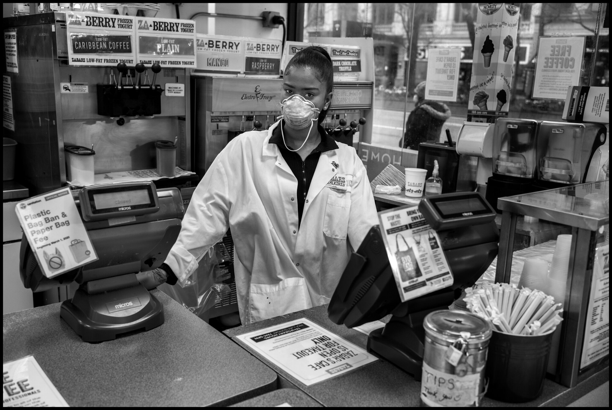  There are so many unsung heroes in the city doing jobs at risk that help us all survive. Aldalkiris 21, works at Zaybars, one of the only stores open on the Upper Westside.  March 28, 2020. © Peter Turnley.   ID# 06-003 