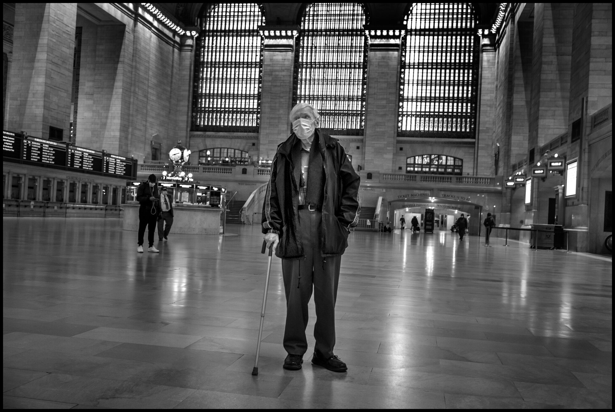  My eyes encountered a lone man, walking with a cane, across the main hall of Grand Central Station. Very often, when I photograph, I don’t simply make one photograph-particularly if it is of a person-I like to do what I call “stay with it-work a sit