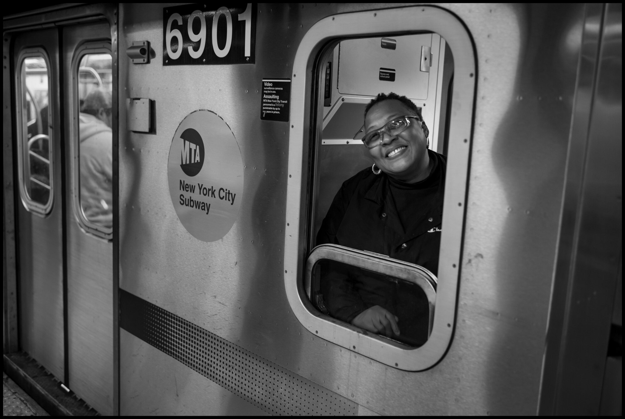  A train conductor, smiles at Times Square.  March 20, 2020. © Peter Turnley.   ID# 01-020 