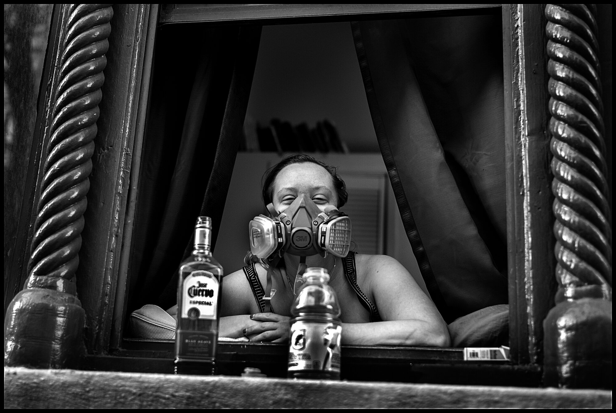  As I walked home, I saw Jamie in a windowsill on a street near where I stay. Jamie, 26, is a pastry chef and is now unemployed because of the crisis. She sat in the windowsill, with a bottle of Tequila, wearing a welder’s dust protection mask, and w