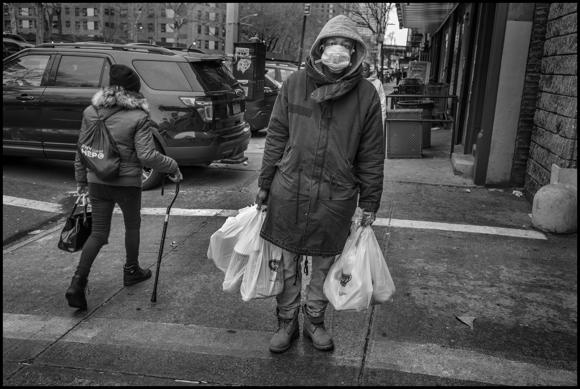  Ernest, 45, returns home from the grocery stores with food, on 125th Street in Harlem.   March 28, 2020. © Peter Turnley.   ID# 06-004 