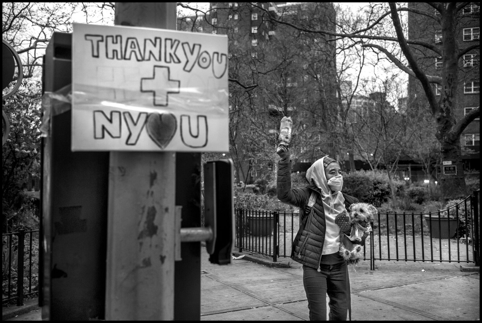  A local resident living near Mount Sinai Hospital joins in with applause and cheering at 7pm to thank all of the hospital workers at Mount Sinai Hospital.  April 19, 2020. © Peter Turnley.   ID# 26-004 