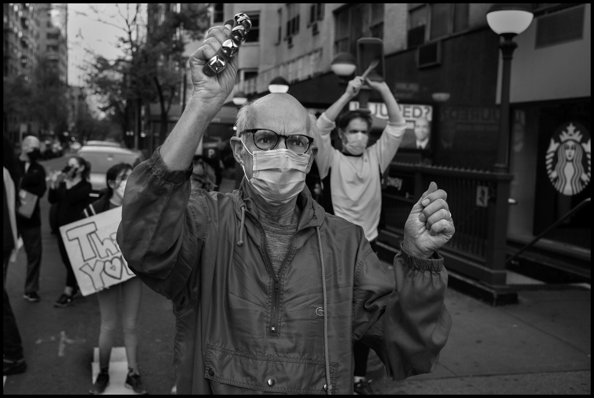  Darrell, a resident of New York’s Upper East Side, thanks the healthcare workers of Lenox Hill Hospital at 7pm.   May 2, 2020. © Peter Turnley.   ID# 36-004 