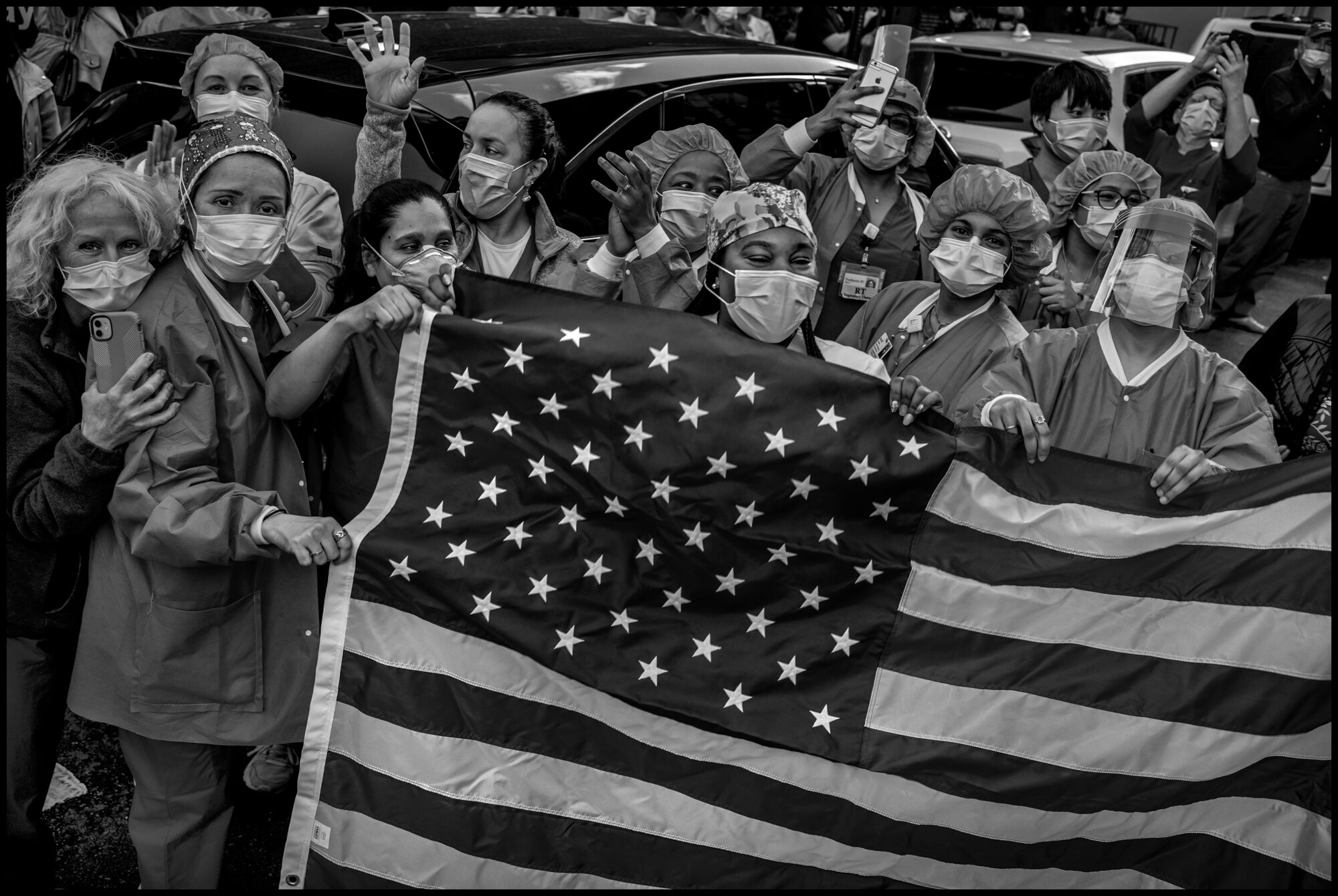 Lenox Hill Hospital Nurses with a US flag at 7pm.  May 1, 2020. © Peter Turnley.   ID# 36-010 