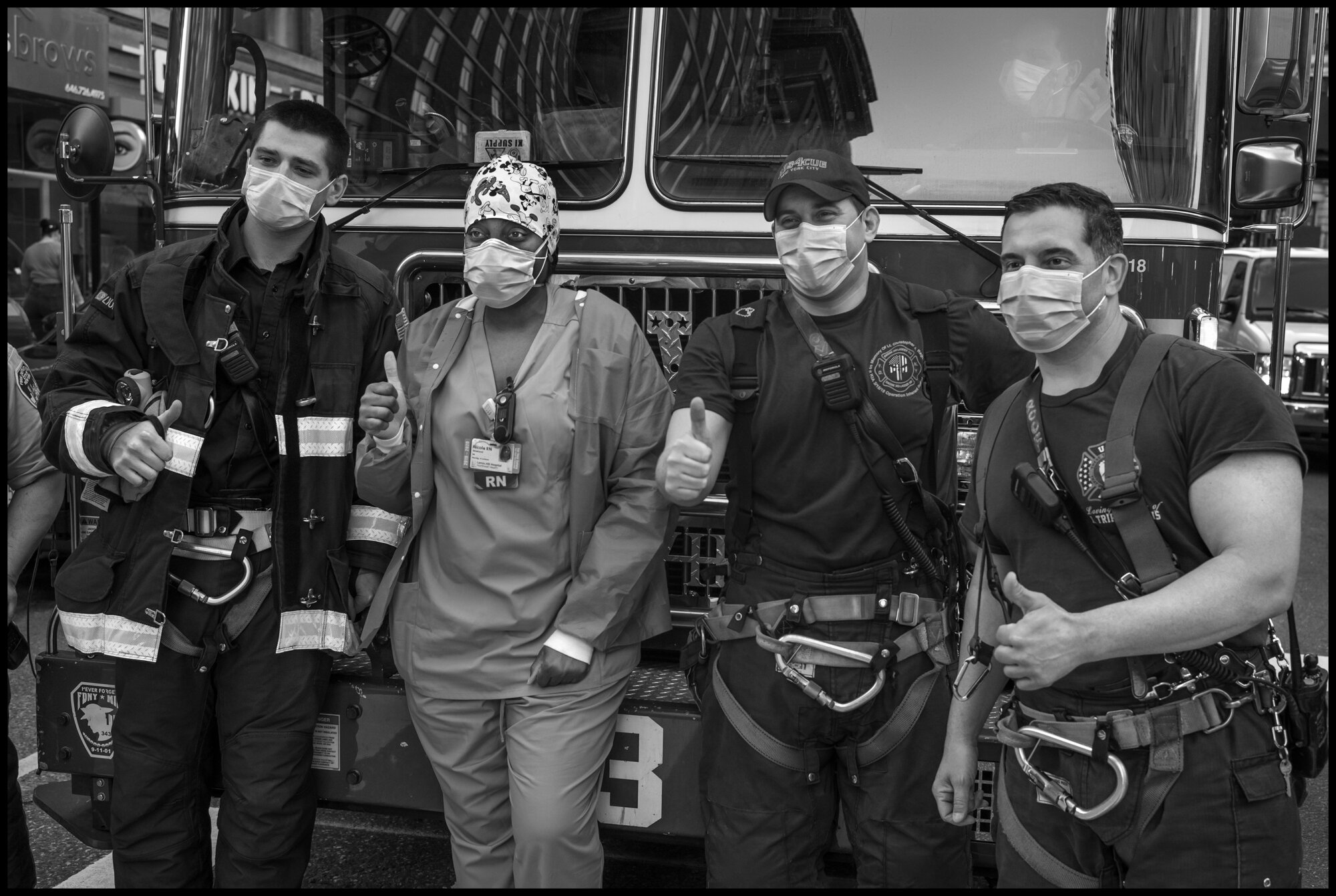  Lenox Hill Hospital nurse with firemen at 7pm.  May 2, 2020. © Peter Turnley.   ID# 36-018 