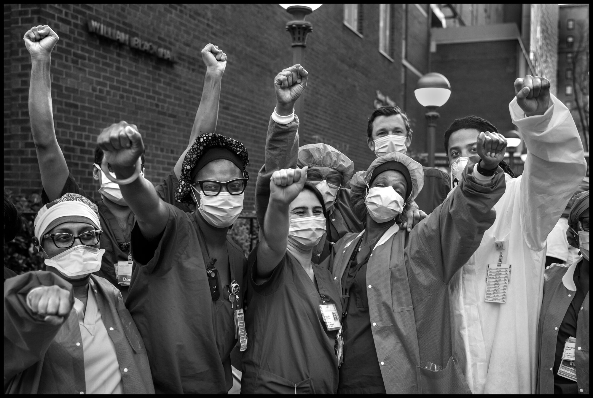  A group of ICU nurses from Lenox Hill Hospital on New York’s Upper Eastside. Sean, 30, one of the nurses, told me, “diversity and unity. There is strength in diversity and unity . We are a team and have to stay together.”   May 3, 2020. © Peter Turn