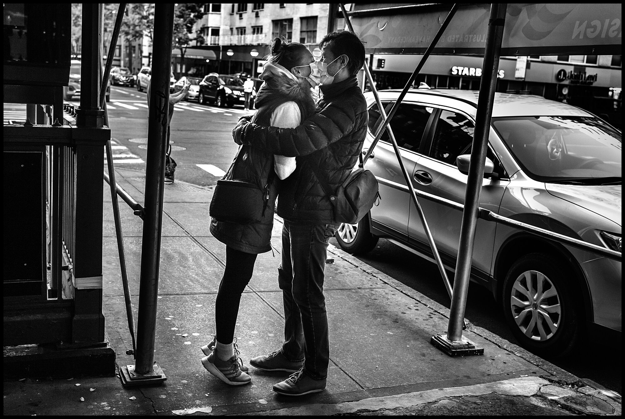  A Coronavirus Kiss! I was speaking to a friend last night outside of Lenox Hill Hospital-and suddenly to my left-just outside a subway entrance-I noticed this tender, masked embrace.   May 13, 2020. © Peter Turnley.   ID# 45-001 
