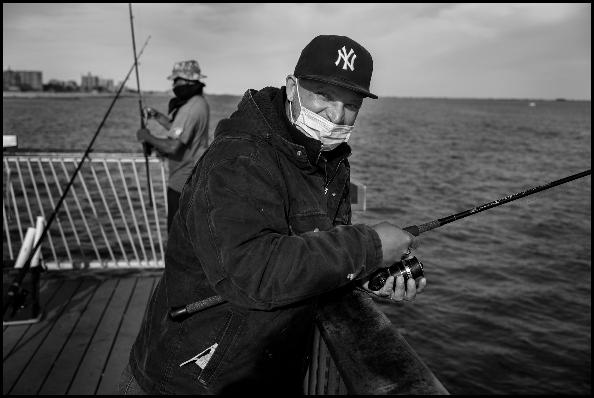  José, comes to fish at the pier in Coney Island almost every day. The pier has been closed several days during the lockdown. Coney Island, New York.  May 16, 2020. © Peter Turnley.  ID# 49-012 