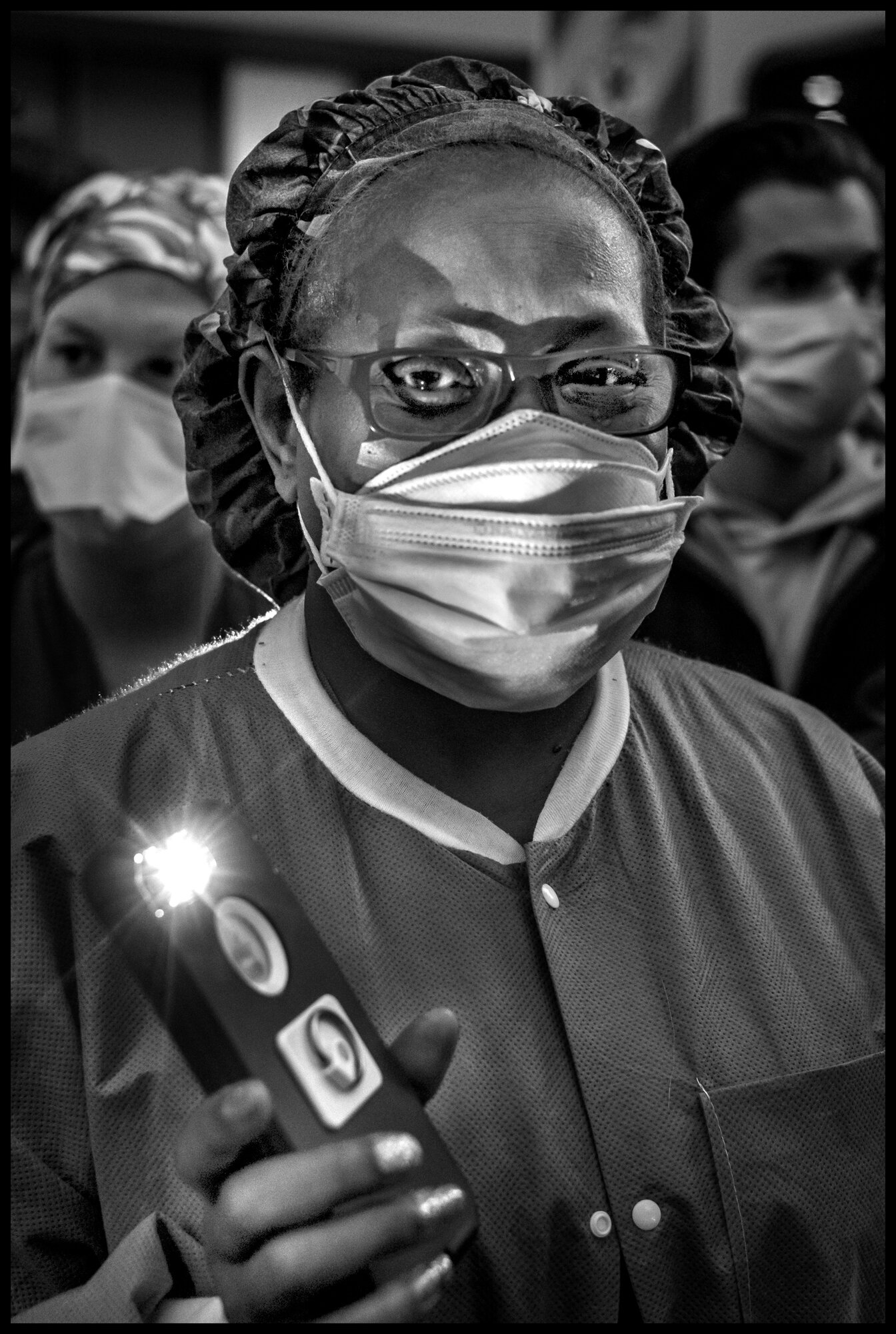  Frontline workers from Lenox Hill Hospital, New York, hold vigil to honor all victims of COVID-19.  May 20, 2020. © Peter Turnley.   ID# 52-001 