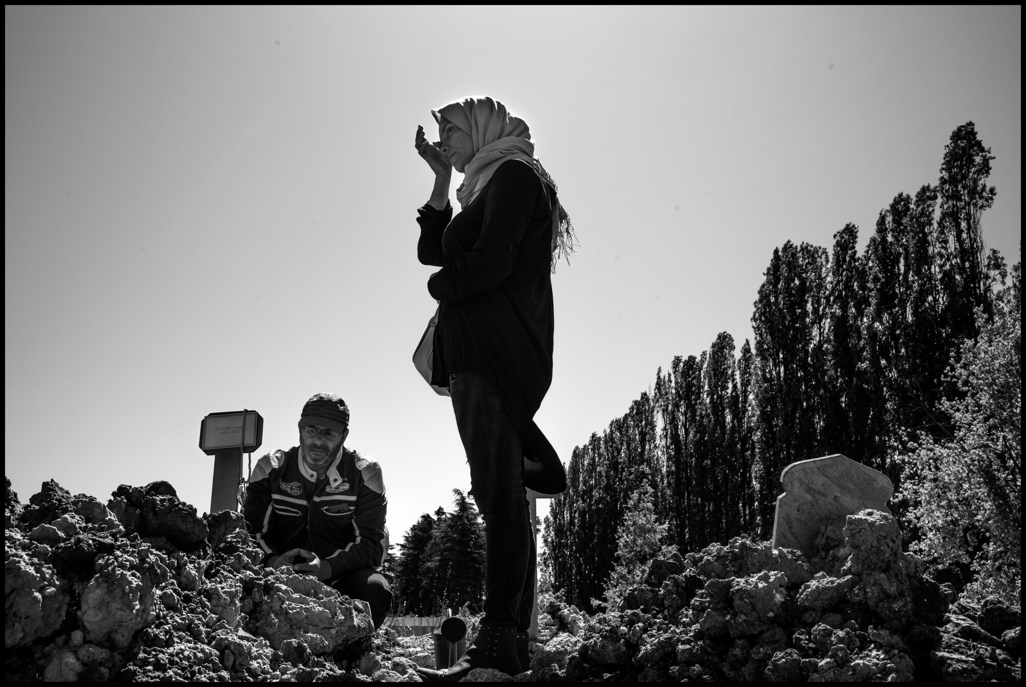  Mimoun, Kader, brothers, and Mimoun’s wife Nadia, came with an Imam, to say prayer for their family member, Ahmed Es-Saad, also dead of Covid-19. St. Denis, France.   May 29, 2020. © Peter Turnley.  ID# P08-002 