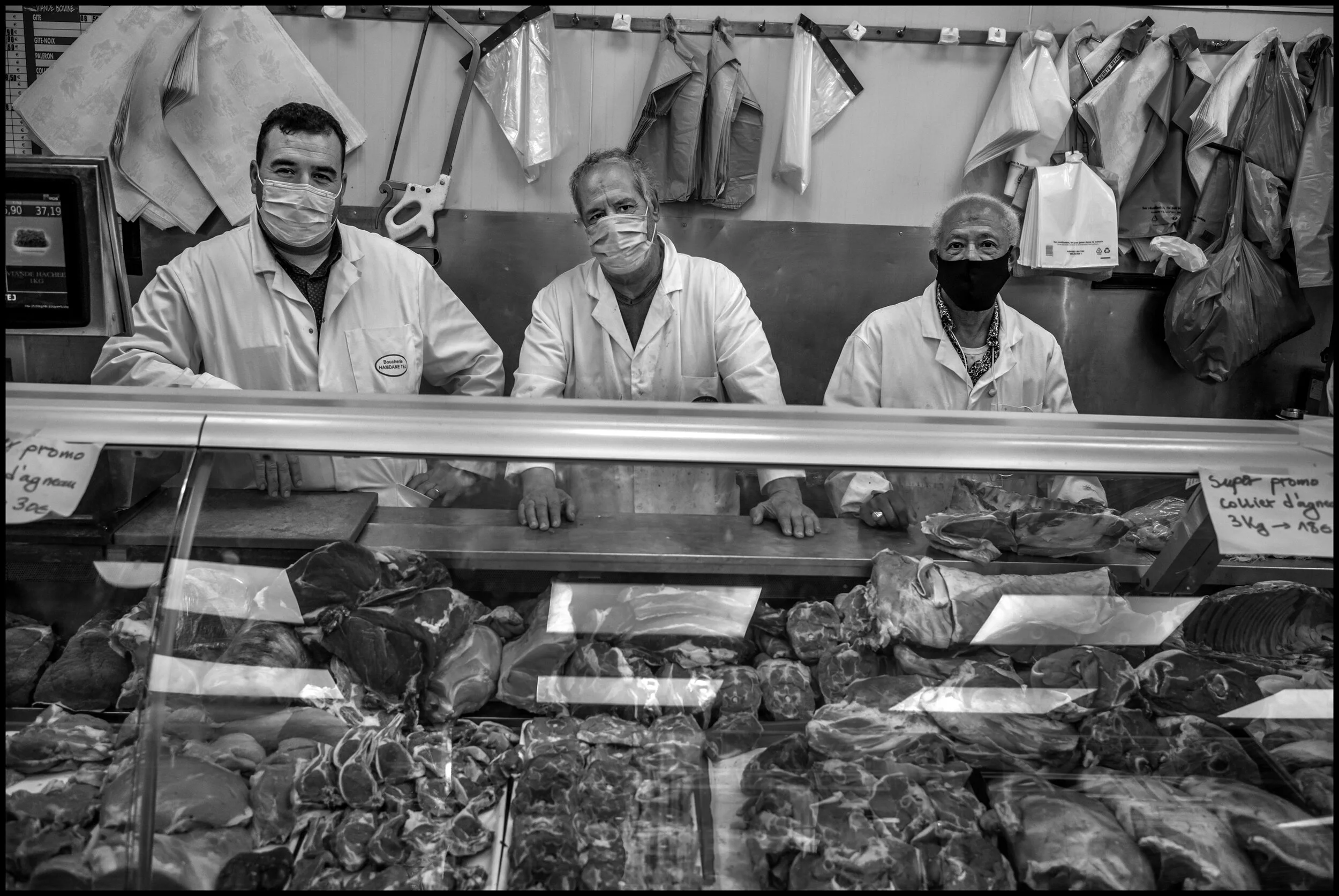  Three butchers, Ahmed, Djilali, and Said, immigrants from Morocco, Algeria, and Tunisia, pose for a portrait at the “Boucherie Hamdane Tej, Boulevard de la Chapelle, Paris.  June 29, 2020. © Peter Turnley.   ID# P47-002 