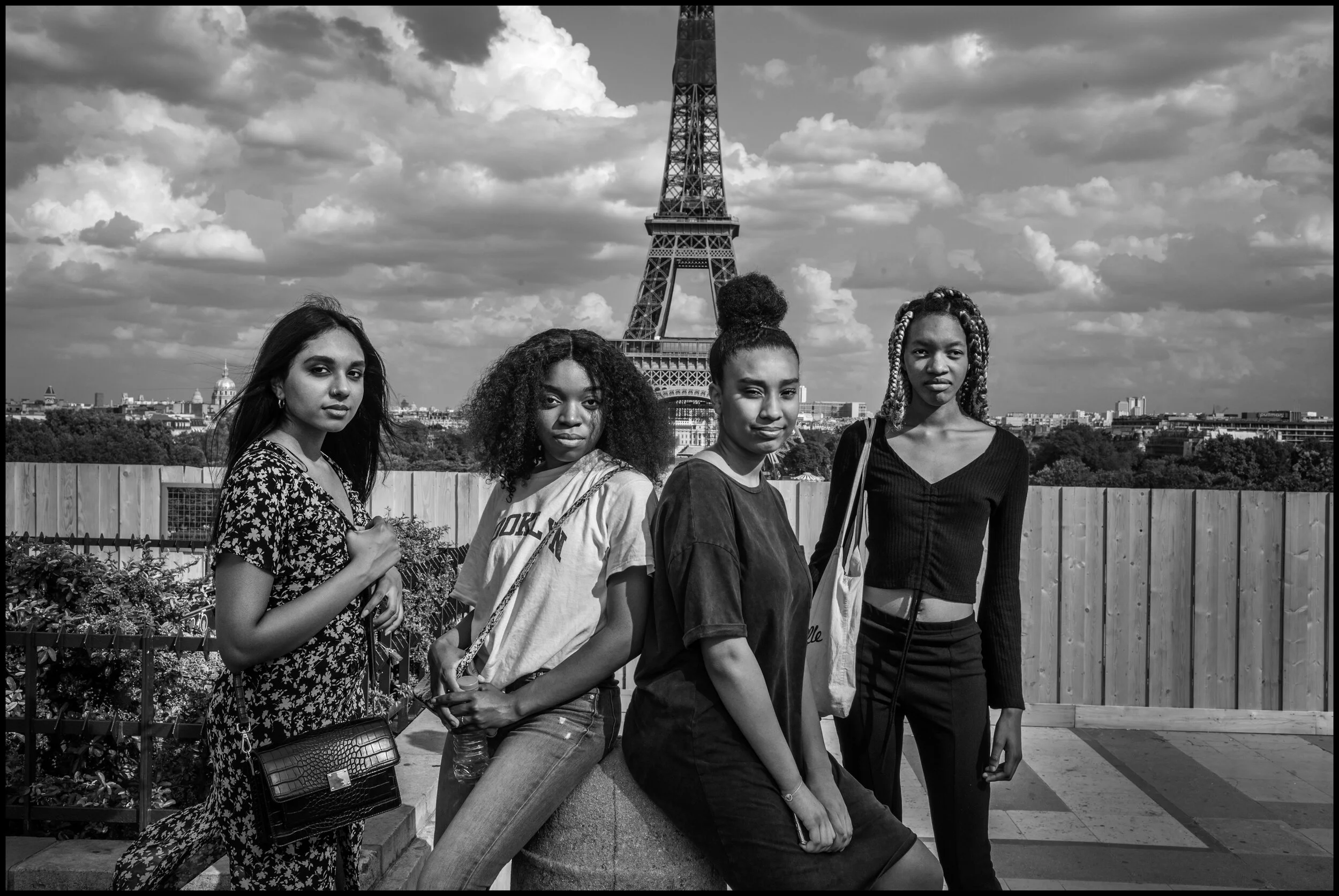  Four young friends from the 14th arrondissement of Paris visiting the Eiffel Tour.They were born in France and their parents are from Morocco, Ivory Coast, The Congo, and the Mauritius Islands. Paris.  June 26, 2020. © Peter Turnley.   ID# P46-008 