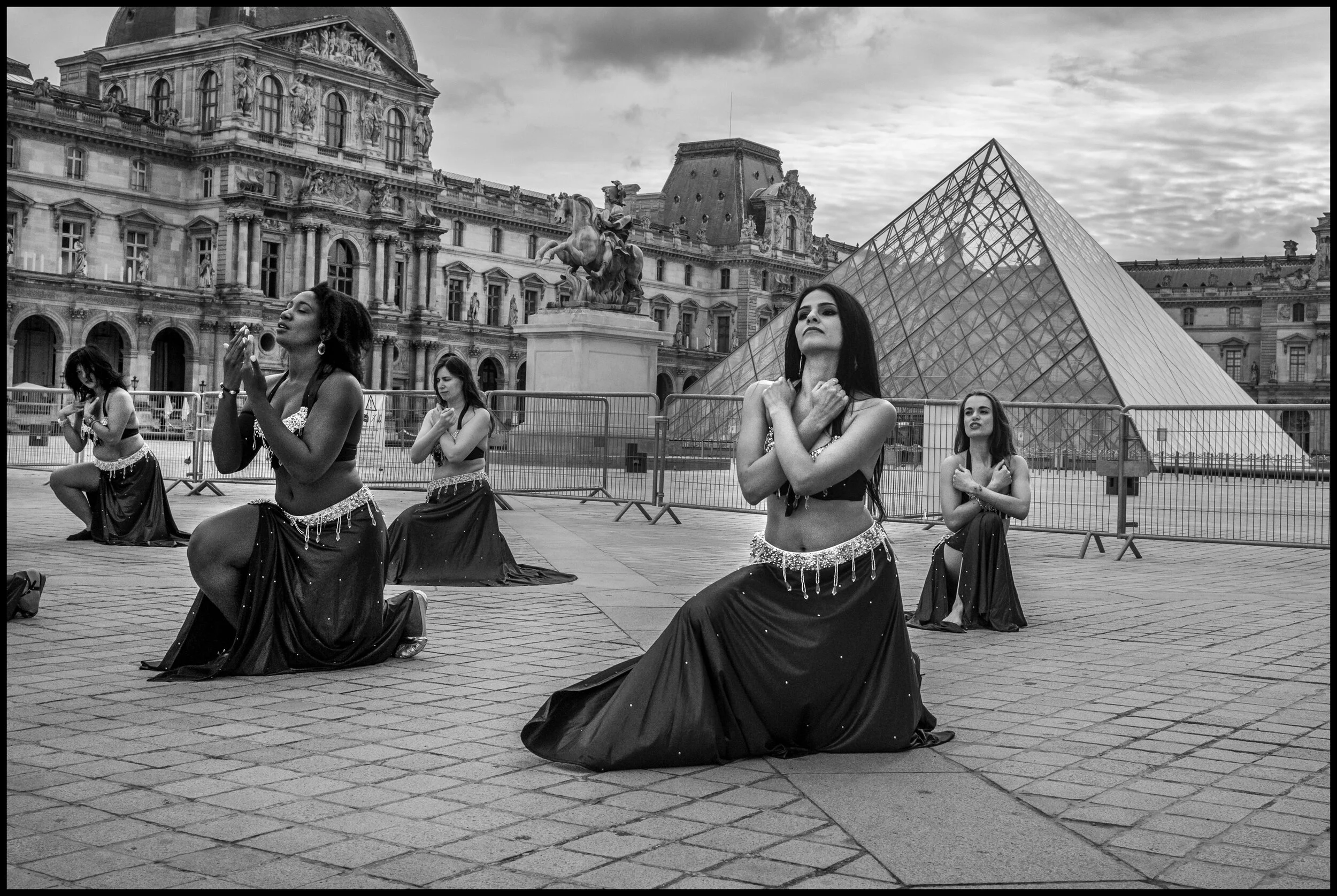  An eastern dance troupe, Pyramide du Louvre, Paris.  June 28, 2020. © Peter Turnley.   ID# P46-014 