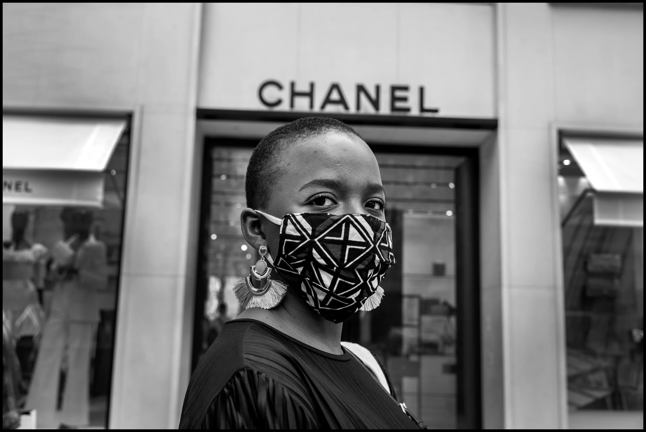  Sarah, originally from Brazzaville in the Congo. She explained to me that she has benefited from the lockdown to quit her job and start a new enterprise designing and selling t-shirts. July 4, 2020. © Peter Turnley.  ID# P53-009 