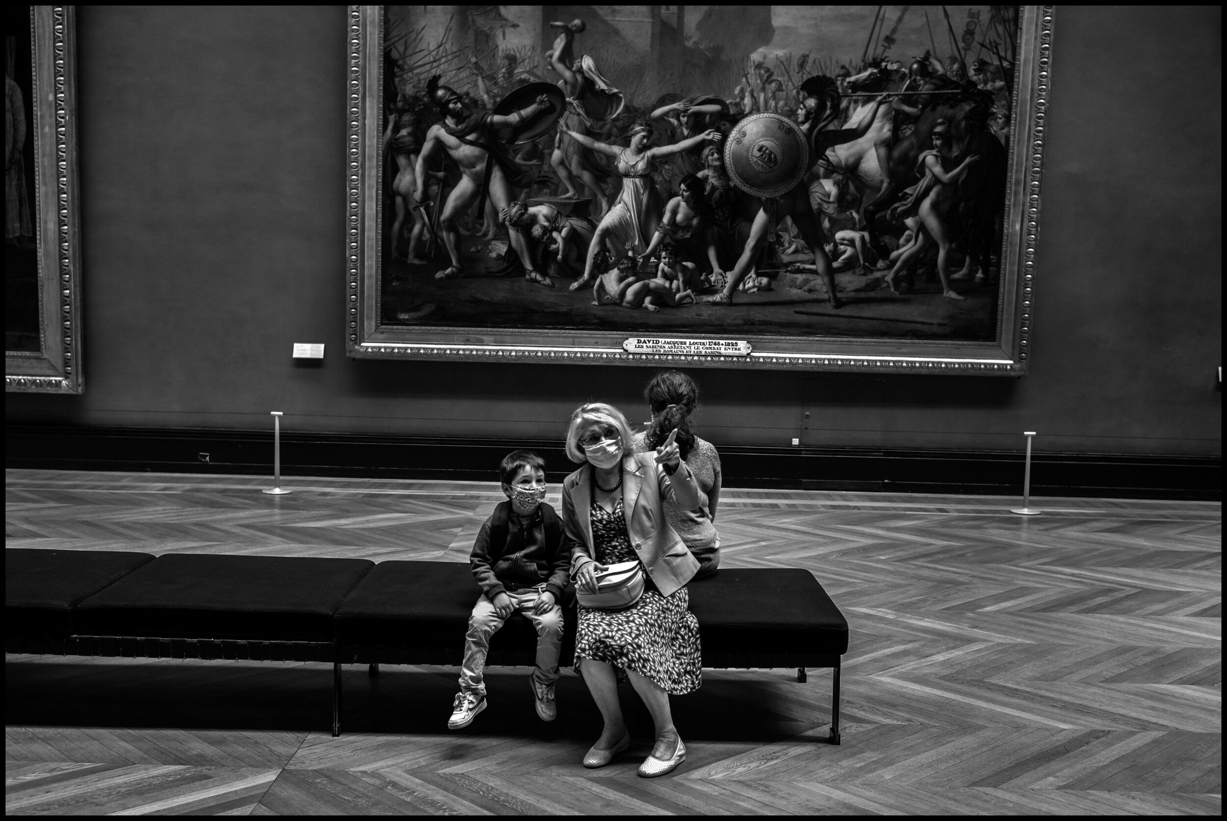  A grandmother discusses a painting with her grandson in the Italian painting section of Le Louvre. July 6, 2020. © Peter Turnley.  ID# P55-007 