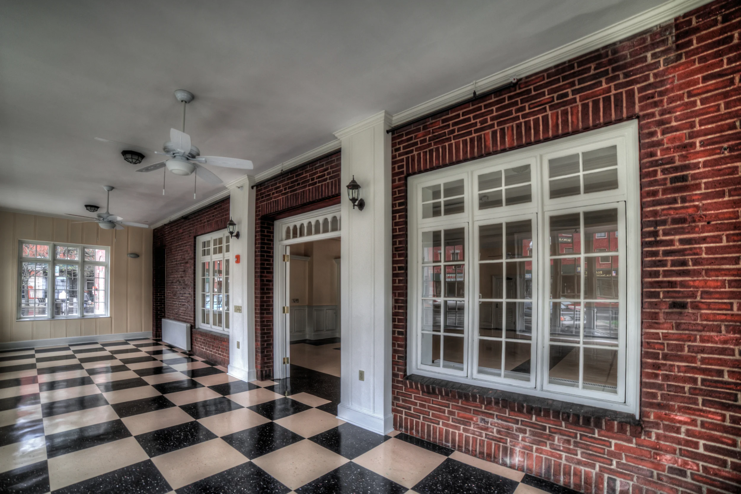 The Hotel Windham Sun Porch, restored in 2010. For years, the business day began here for many in Bellows Falls and it serves today as dining and event space sponsored by Popolo and various village organizations. Inside the original french doors, pictured open above, is the Hotel Windham Ballroom. The Boston & Maine railroad tunnel runs directly beneath these rooms.
