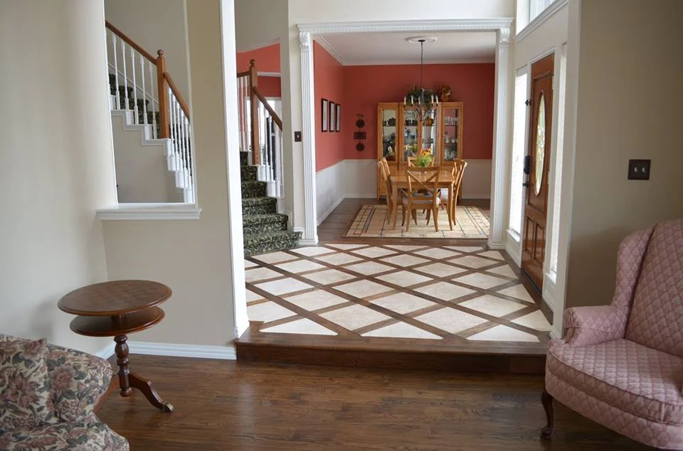 Naildown handscrape laced around 18x18 travertine.