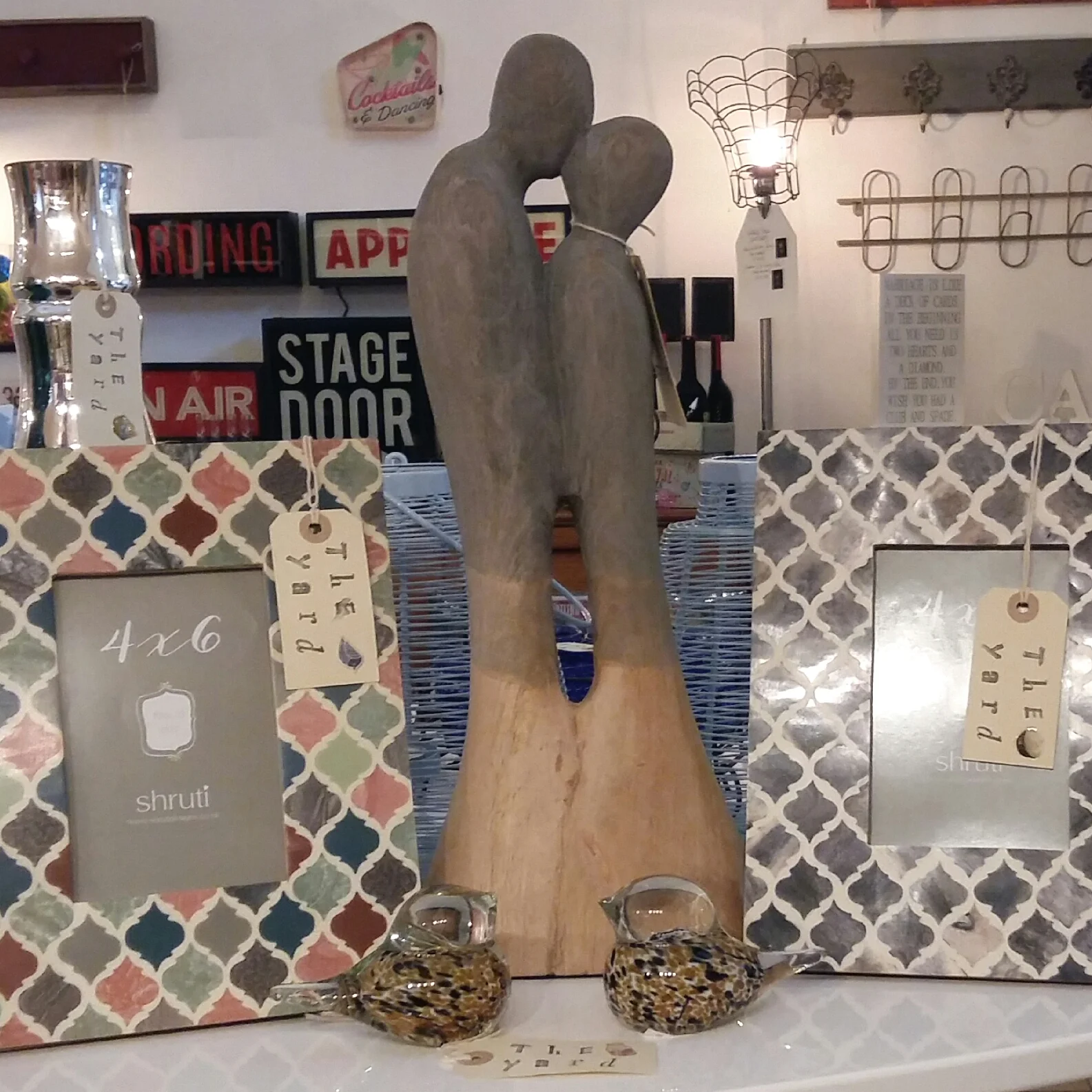 Kissing couple wooden figure, Moroccan inspired frames and small glass birds.