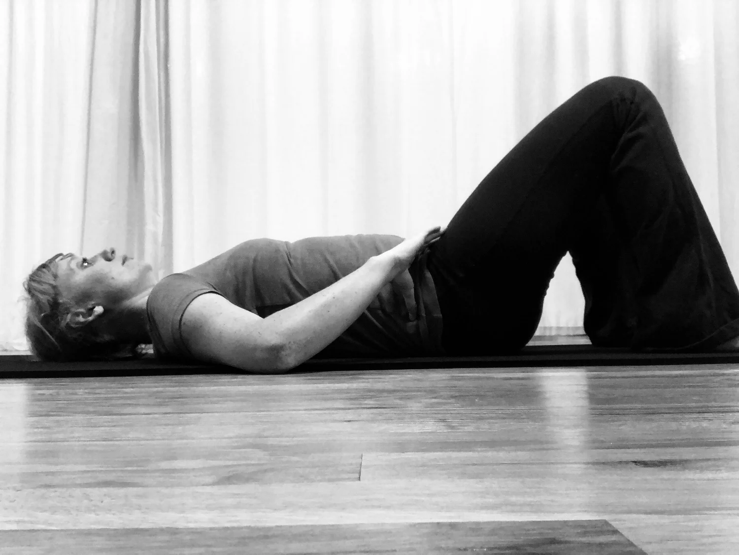 1. Begin on your back. Place hands on the hip bones. 2. Gently flatten the low back into the mat, tilting the pubic bone slightly up towards the ceiling. 3. Gently arch the low back, tilting the pubic bone slightly towards your heels. Keep in mind these are small movements and you only want your pelvis to move. Try not to engage your glutes or thighs to move the pelvis, but allow the low abdominals to do the work.