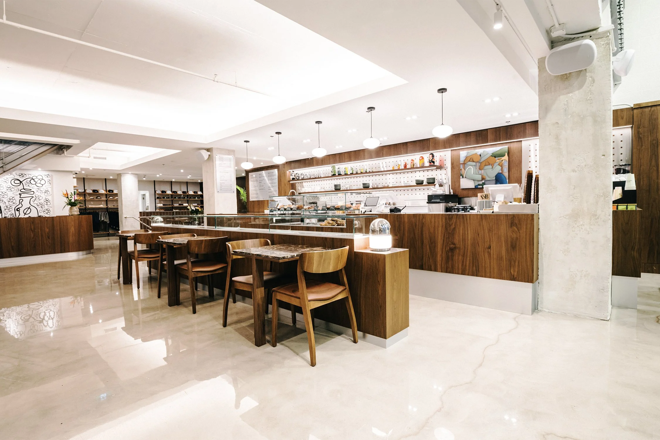 Empire café lounge designed by Finkel' featuring seating, stone tables, and a double-height hospitality interior