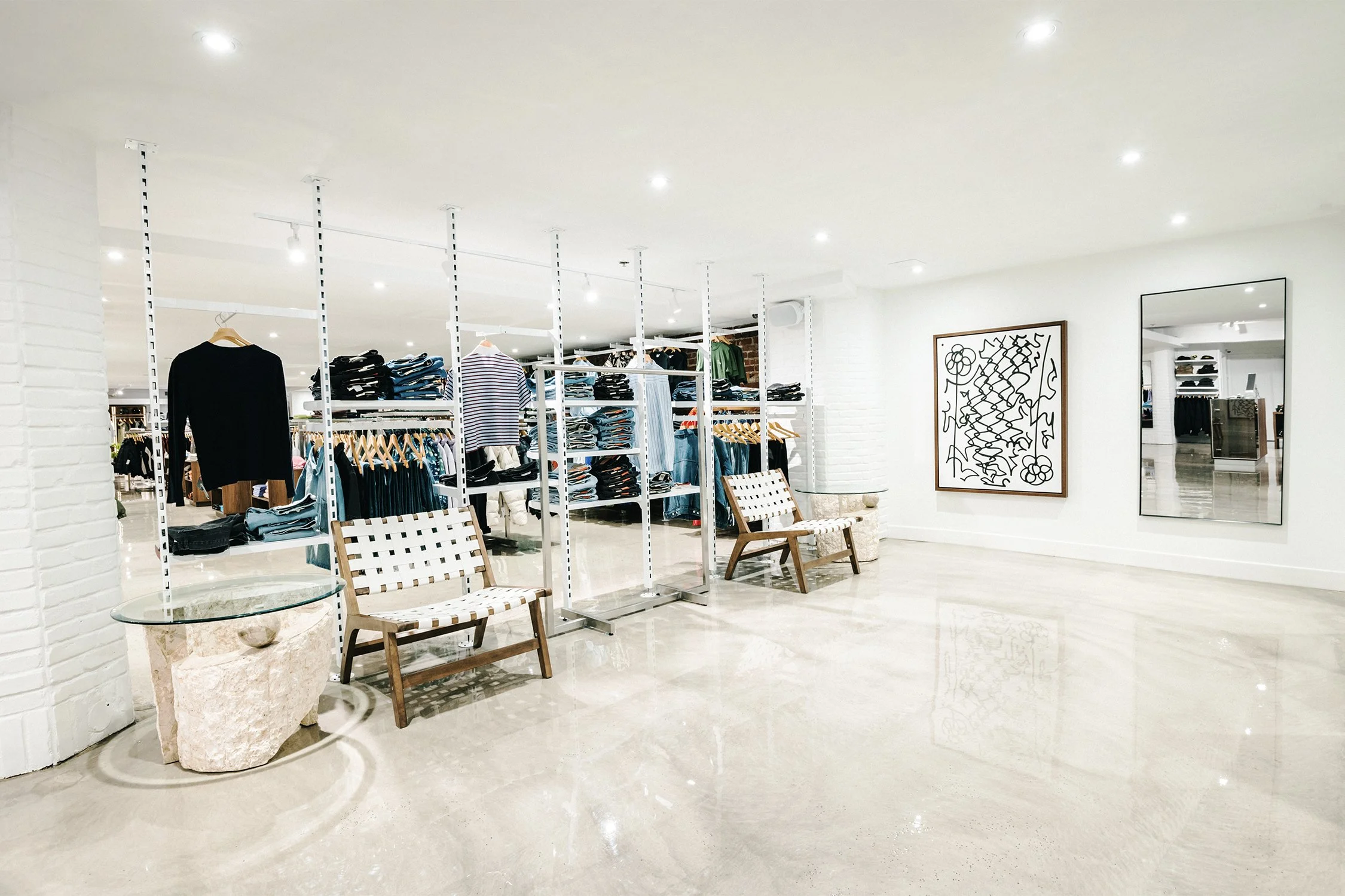 Flexible retail layout with modular clothing racks and custom fixtures designed by Finkel' for Empire flagship store