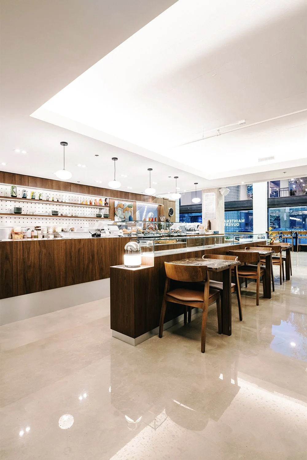 Custom café service counter designed by Finkel for Empire, featuring wood millwork and a clean modern hospitality layout