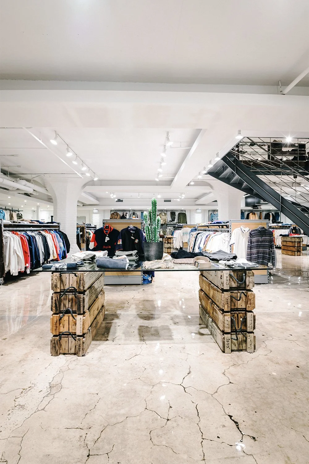 Central retail aisle and custom display platforms designed by Finkel' inside Empire’s flagship store