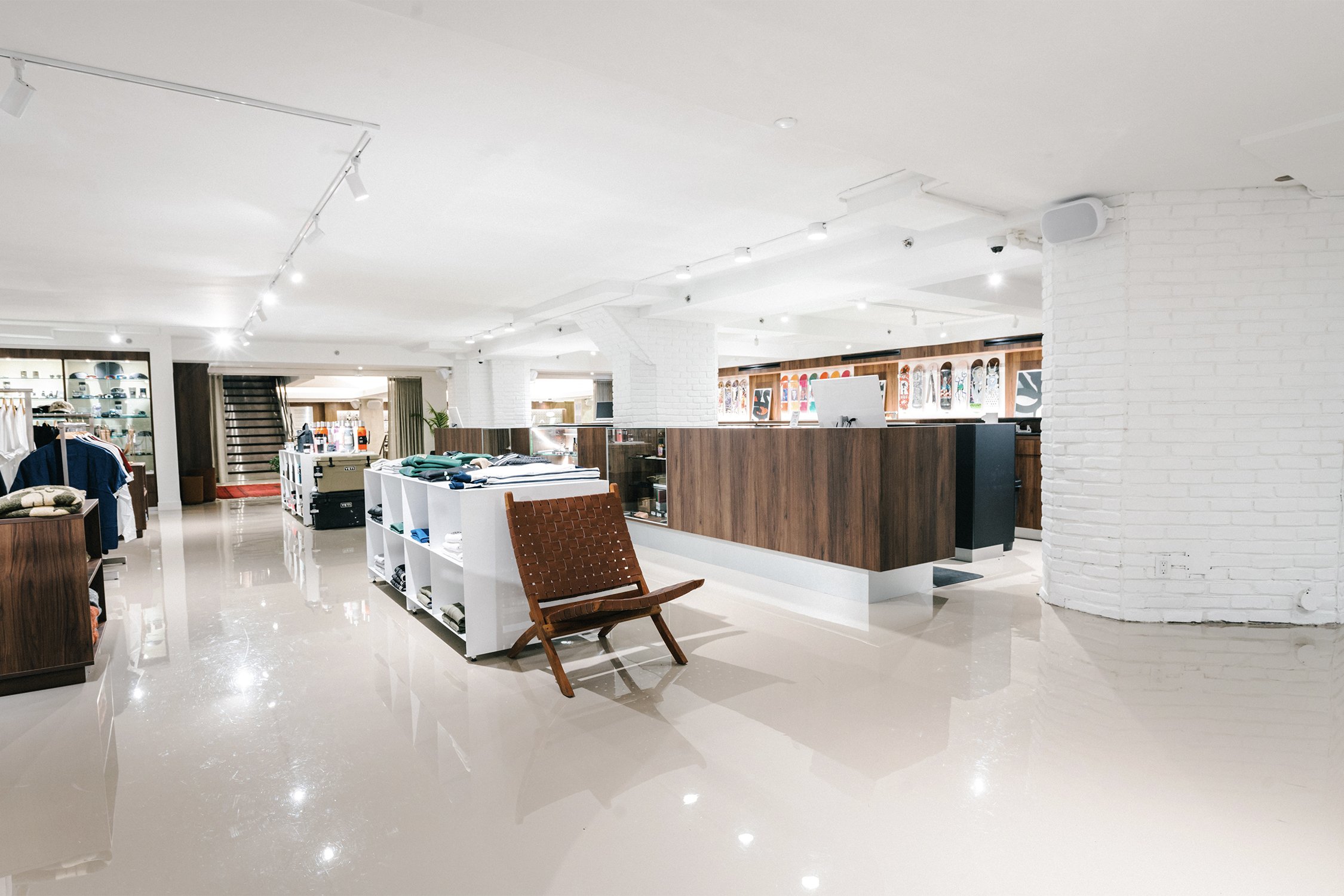 Open-plan retail interior with custom wood service counter and merchandise displays designed by Finkel' for the Empire flagship store