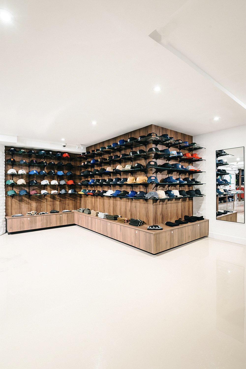 Custom hat wall and wood display system designed by Finkel' for Empire’s flagship retail store
